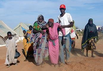 Sudanese_refugee_helped_to_her_assigned_tent_20040119.jpg