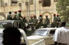 Sudanese_army_soldiers_escorting_another_truck_full_of_prisoners_through_the_streets_of_central_Khartoum_in_Sudan_Sep._30_2004.jpg