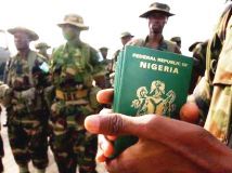 A_Nigerian_officer_holds_passports.jpg