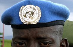 A Rwandan UN Peacekeeper waits to board a UN plane at Kigali Airport in November 2005 to be dispatched to Sudan's capital Khartoum.