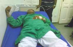 Mubarak Al-Fadil lying in hospital bed