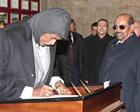 File photo showing Former press secretary Mahjoub Badri signing the guestbook in Atatürk's mausoleum on January 21, 2008 as President al-Bashir (right) looks on.