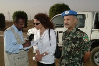 Radhia Achouri (center) being interviewed. (UNMIS)