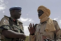 A handout photo shows General Martin Luther Agwai, overall commander of the United Nations-African Union Mission in Darfur (UNAMID) talking with a field commander of the Sudan Liberation Army (SLA) Unity faction in El Hosh, north Darfur March 9, 2008 (Reuters)