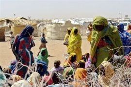 Sudanese women wait outside a food aid distribution facility in South Darfur.(file photo)