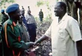 Riek Machar (r) greets Joesph Kony near Congolese border last year