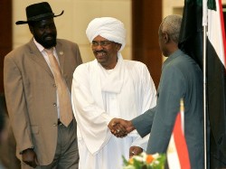 Sudan's First Vice President Salva Kiir (L), also leader of the semi-autonomous south Sudan, looks on as Sudanese President Omar al-Beshir (C) shakes Vice President Ali Osman Taha (R) at the signing ceremony of the new electoral law, approved by parliament last week in the capital Khartoum on July 15 2008 (AFP)
