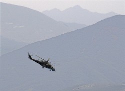 A Russian military helicopter secures the mountains around the Georgian city of Gori, August 15, 2008 (Reuters)