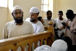 Two of the five Sudanese accused of killing an American diplomat working with the USAID and his Sudanese driver, almost a year ago, looks on before their trial in Khartoum, Sudan, Sunday, Aug. 31, 2008 (AP)