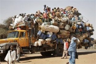 Displaced Darfurians arrive by truck at the Zamzam refugee camp in northern Darfur, Sudan, Thursday, Feb. 26, 2009. (AP)