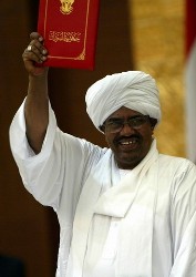 In this fiel photo Sudan's President Omar Hassan al-Bashir holds Sudan's new election law book in Khartoum July 14, 2008 (Reuters)