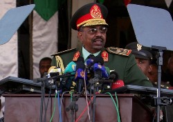 Sudan's President Omar Hassan al-Bashir addresses a military parade during Independence Day celebrations in Khartoum, December 31, 2008 (Reuters)