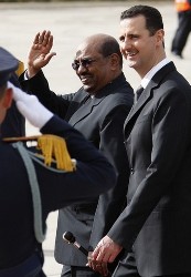 Syria's President Bashar al-Assad (R) welcomes his Sudanese counterpart Omar Hassan al-Bashir at Damascus airport last year. (Reuters)