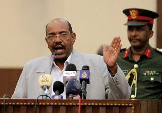 Sudanese President Omar Al Bashir greets supporters in Toti (an island between Blue and White Nile rivers) in Khartoum, Sudan, Saturday, March 21, 2009 (AP)