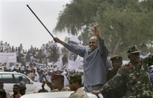 Sudan's president Omar al-Bashir waves to thousands of supporters at a rally in Sabadou near the southern Darfur town of Nyala, in Sudan, Wednesday, March 18, 2009 (AP)