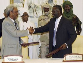 Sudanese rebel Justice and Equality Movement (JEM) representative Gibril Ibrahim (R) shakes hands with Amin Hassan Omar, a member of the Sudanese government delegation, after the signing of an agreement of good intentions, in Doha, February 17, 2009. (Reuters)
