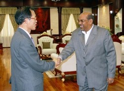 Liu Guijin, China's special envoy on Darfur, left, is greeted by Sudanese President Omar al-Bashir during their meeting in Khartoum, Sudan last year (AP)