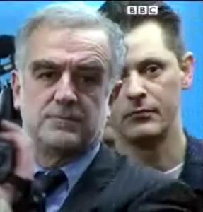 TV footage showing the International Criminal Court prosecutor Luis Moreno-Ocampo with a security officer standing behind him at a press conference in the Hague March 4, 2009 (BBC)