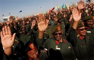 Sudanese army officers raise their hands in a pledge of allegiance for Sudanese President Omar al-Bashir, unseen, during rally for the military in Khartoum, Sudan, Monday, March 16, 2009 (AP)