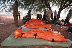 A handout picture from the African Union Mission in the Sudan (AMIS) shows AMIS personel placing bodies of dead colleagues into body bags at Haskanita military group site (MGS) 30 September 2007 following an attack (AFP)