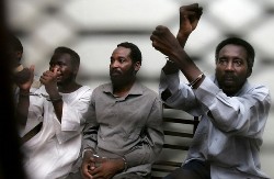 Abdul Aziz Ashr, brother-in-law of Justice and Equality Movement (JEM) leader Khalil Ibrahim (R), and unidentified co-defendants are seen here at a court hearing in North Khartoum in which the top Darfur rebel and seven others were sentenced to death on 17 August 2008 (AFP)