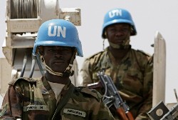 A picture made available by Albany Associates shows Nigerian soldiers serving with the United Nations-African Union Mission in Darfur (UNAMID) standing atop an armoured personnel carrier (AFP)