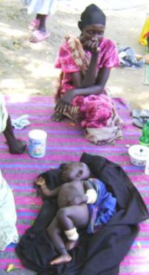 This photo shows the five-months-old girl (center) rescued from Murle men being look after by her grandmother (left) in Bor Civil Hospital, on Thursday, April 23 ( photo by Ph. Thon Aleu)