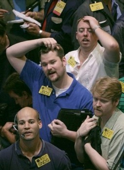 Oil traders react during trading activity on the floor of the New York Mercantile Exchange (AP)
