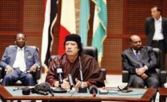 Libyan leader Muammar Gadhafi speaks after the signing of a peace accord between Chadian President Idriss Deby (L) and leaders of Chad's four main rebel in Sirte, in October 2007