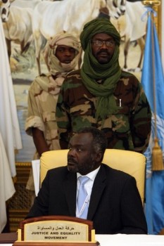 Sudanese rebel group Justice and Equality Movement (JEM) leader Khalil Ibrahim (back) stands behind his brother Jibril Ibrahim during the signing in Doha, Qatar on February 17, 2009 (AFP)