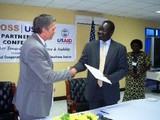 General_Oyai_Deng_Ajak_agrees_to_the_MOU_with_USAID_official_Earl_Gast_June_15_2009.jpg