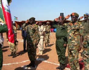 Salva Kiir (C) saluting the flag with General James Hoth (R) and  General Oyai Deng Ajak, in Juba on June 5, 2009 (Larco Lomayat)