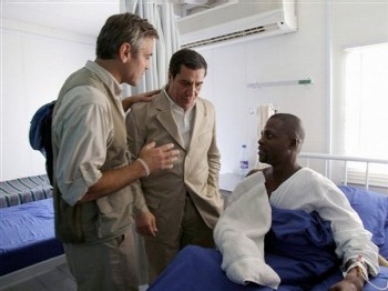 In this January 2008 photo released by the United Nations and African Mission in Darfur (UNAMID), actor George Clooney, left, and UNAMID spokesman Noureddine Mezni, center, talk with an African Union peacekeeper injured during the attack on his base in September 2007 at El Fasher, in Darfur, Sudan (AP)