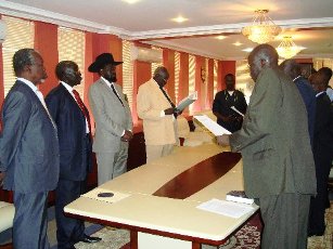 Presidential Advisor on Food Security, Dr. Michael Milly, the Minister for Telecommunications and Postal Service, H. E. Lt. Gen. Madut Biar and Minister for Culture, Youth and Sports in GOSS Mr. Gabriel Changson Chang taking oath of office before the President Salva Kiir, on June 9, 2009 (Lrco Lomayat)