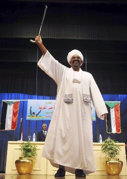 Sudan's President Omar Hassan al-Bashir waves to supporters at an event organized by the Sudanese embassy in Cairo July 17, 2009 (Reuters)