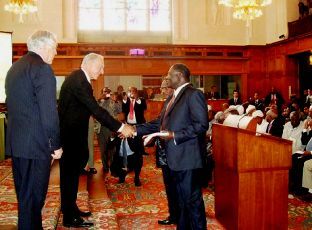 Dr. Riek Machar for the SPLM (R) and Ambassador Dirdeiry Mohamed Ahmed (L) receives the Abyei Final Award from Pierre-Marie Dupuy Presiding Arbitrator in The Hague on July 22, 2009 (photo Moses Lomayat)