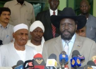 Sudan First Vice President Salva Kiir Mayadrit (L) and leader of Umma Party talk to the press following their meeting in Khartoum on July 14, 2009 (SUNA)