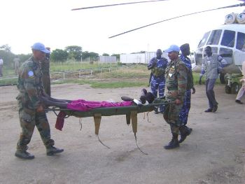 UNMIS soldiers carry a wounded man at Bor airstrip Monday September 21, 2009(ST)