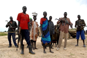Armed civilians and some women near the market area of the southern Sudanese village of Duk-Padiet which suffered recent attack by Lou Nuer, Tuesday, Sept. 22, 2009 (Timothy Mckulka-UNMIS)