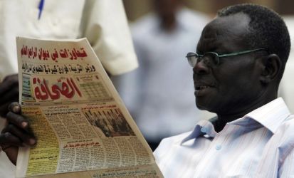 A Sudanese man reads a local Arabic newspaper in Khartoum on April 27, 2009. (Getty)