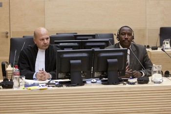A solicitor looks on as the Darfur rebel chief Bahr Idriss Abu Garda (R) appears before the International Criminal Court (ICC) in The Hague on May 18, 2009. (AFP)