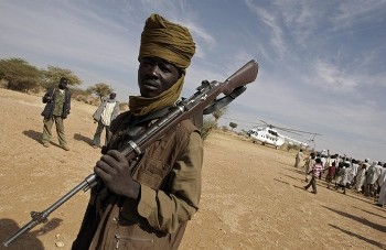 In this photograph made avaliable by Albany Associates, a fighter of the Sudan Liberation Army (SLA) Wahid-Nur faction stands guard (AFP)