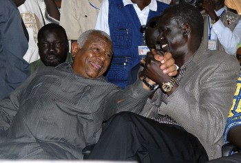 Sudan's State Minister for Humanitarian Affairs, Abdul-Bagi Al-Jailani, and Foreign Minister Deng Alor celebrate the decision of the Permanent Court of Arbitration in the Hague in Abyei, central Sudan, July 22, 2009 (Reuters)