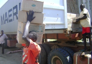A porter offload a truck of good in Bor, Nov. 2, 2009 (Photo by Philip