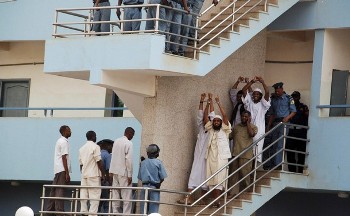 File - Four Sudanese convicts lift their handcuffs as they are escorted out of the courtroom in the capital Khartoum, June 24, 2009 (Reuters)