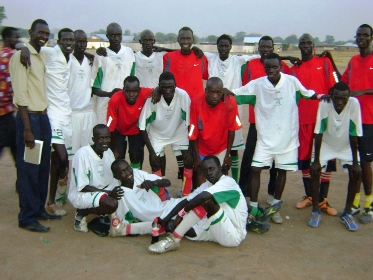 Defeated John Garang Institute players (in red T-shirts) pose for a group with White Cock players (in white T-shirts) on Tuesday Dec. 1, 2009 in Bor town (By Philip Thon Aleu -- ST)