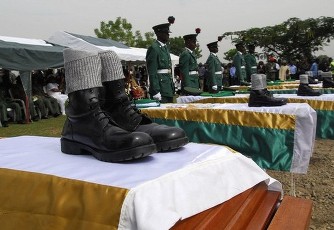 FILE - Troops stand behind the coffins of Nigerian peacekeepers killed in Darfur during a funeral ceremony in Abuja October 5, 2007 (Reuters)