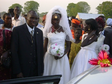 Michael Reech Madit (L) and Rachael Yar Panchol (R) leave the church after wedding prayers on Monday Jan. 26, 2010 (Photo by Philip Thon Aleu -- ST)