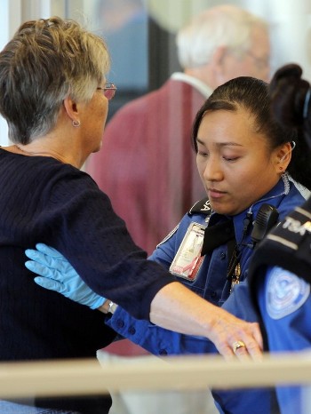 A Transportation Security Administration (TSA) officer carries out a physical search on a passenger at a security checkpoint at Newark Liberty International Airport in New Jersey December 29, 2009 (Reuters)