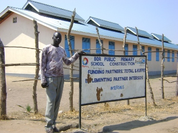 Bor Public headteacher poses for a photo in front of one the classrooms blocks funded by France Total Oil Co. in Bor twon on Monday Jan. 11, 2010 (Photo By Philip Thon Aleu -- ST)